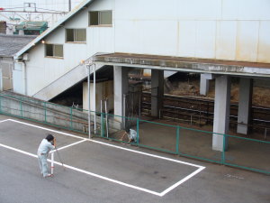 階段下で測量作業